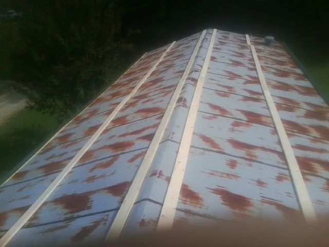 Rusted metal roof panels with new wood purlins before replacement — Storm Damage Roof Repair in Mehoopany by Roofing Brothers